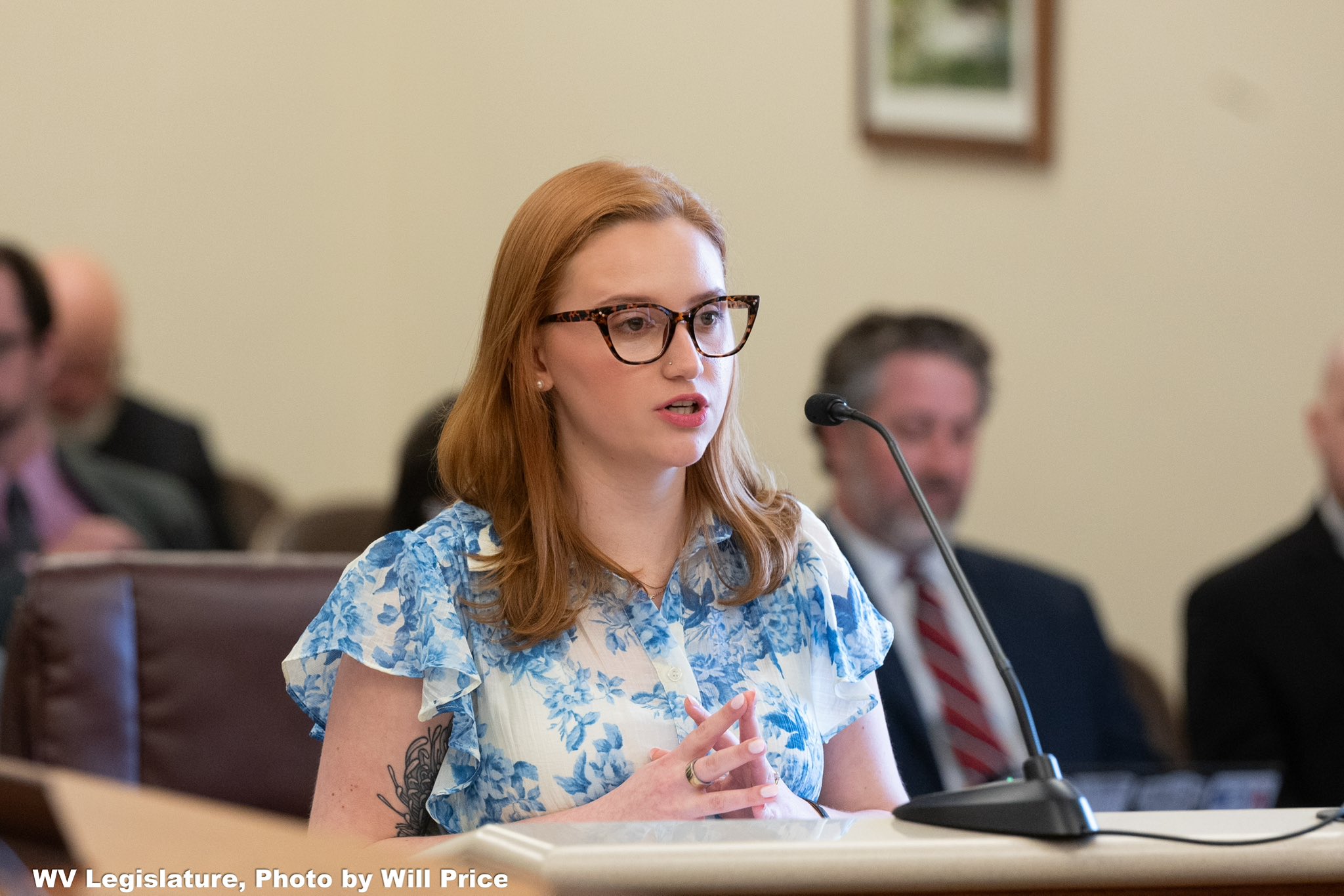 Community in Action: PBM Testimony A woman speaking into a microphone during legislative testimony.